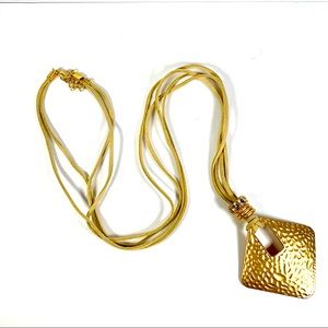 Leather necklace with gold colored pendant